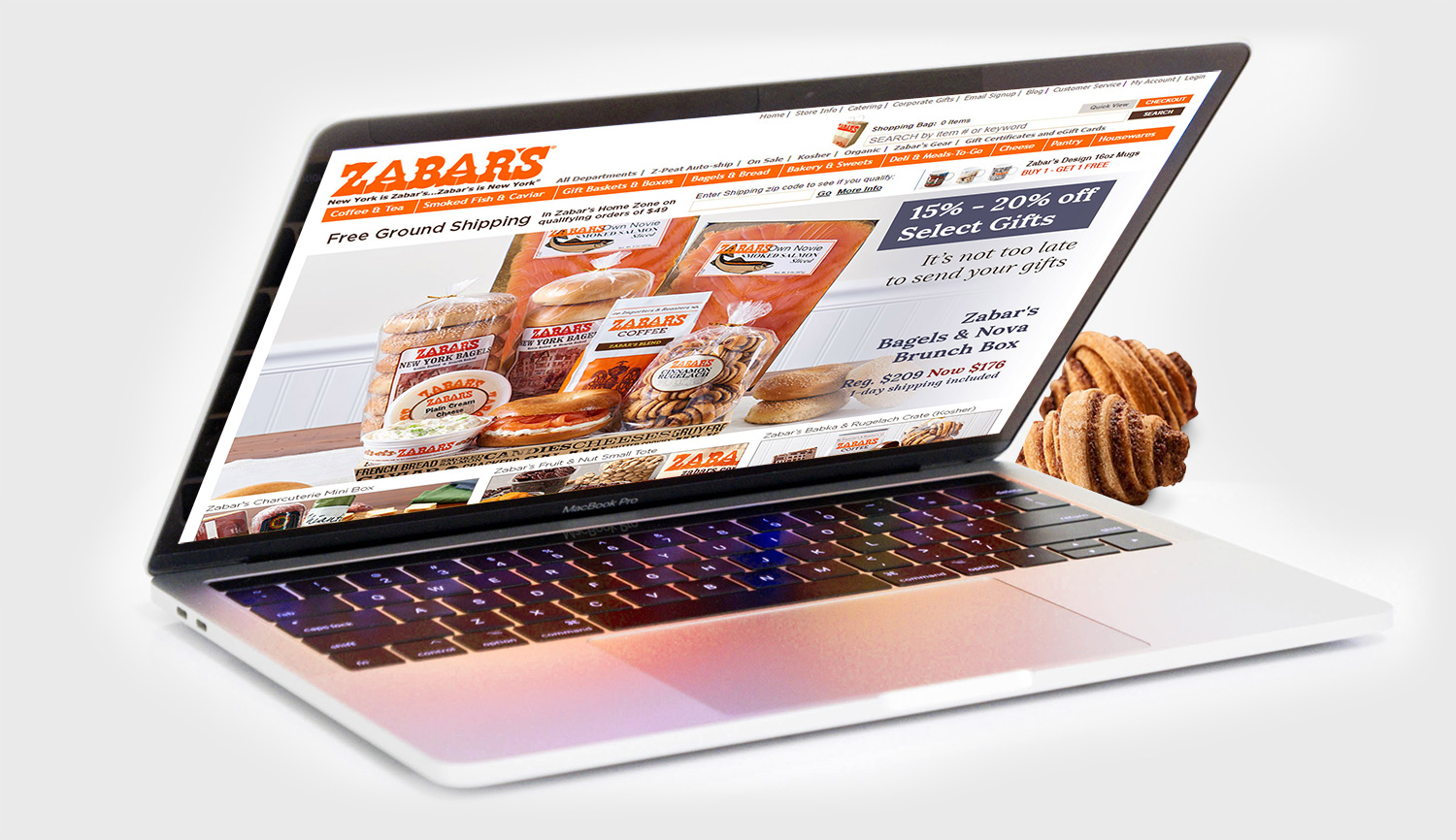 mobizcorp_ecommerce_zabars_salesforce_laptop with the online store open and two mini croissants next to it